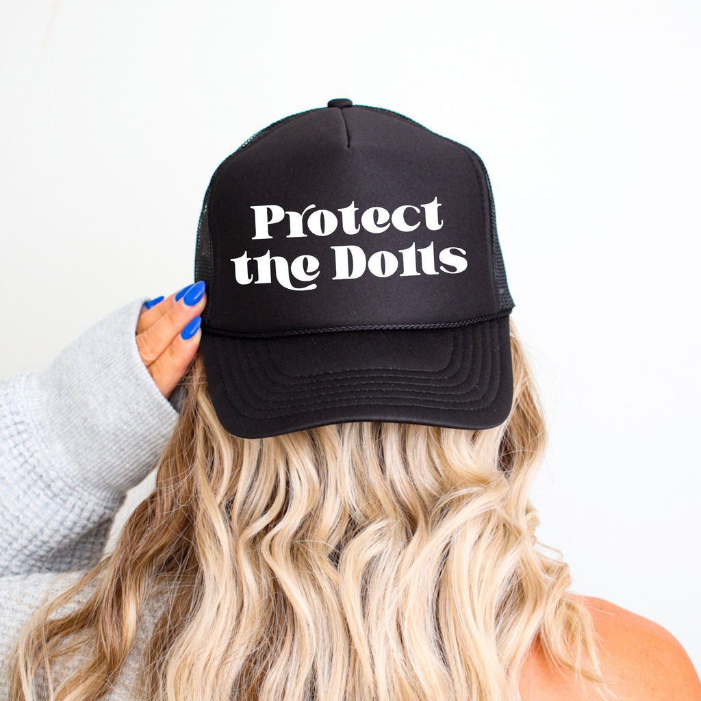 Protect The Dolls Bold Slogan Graphic For Real Talk Style Enthusiasts And Trendsetters Trucker Hat