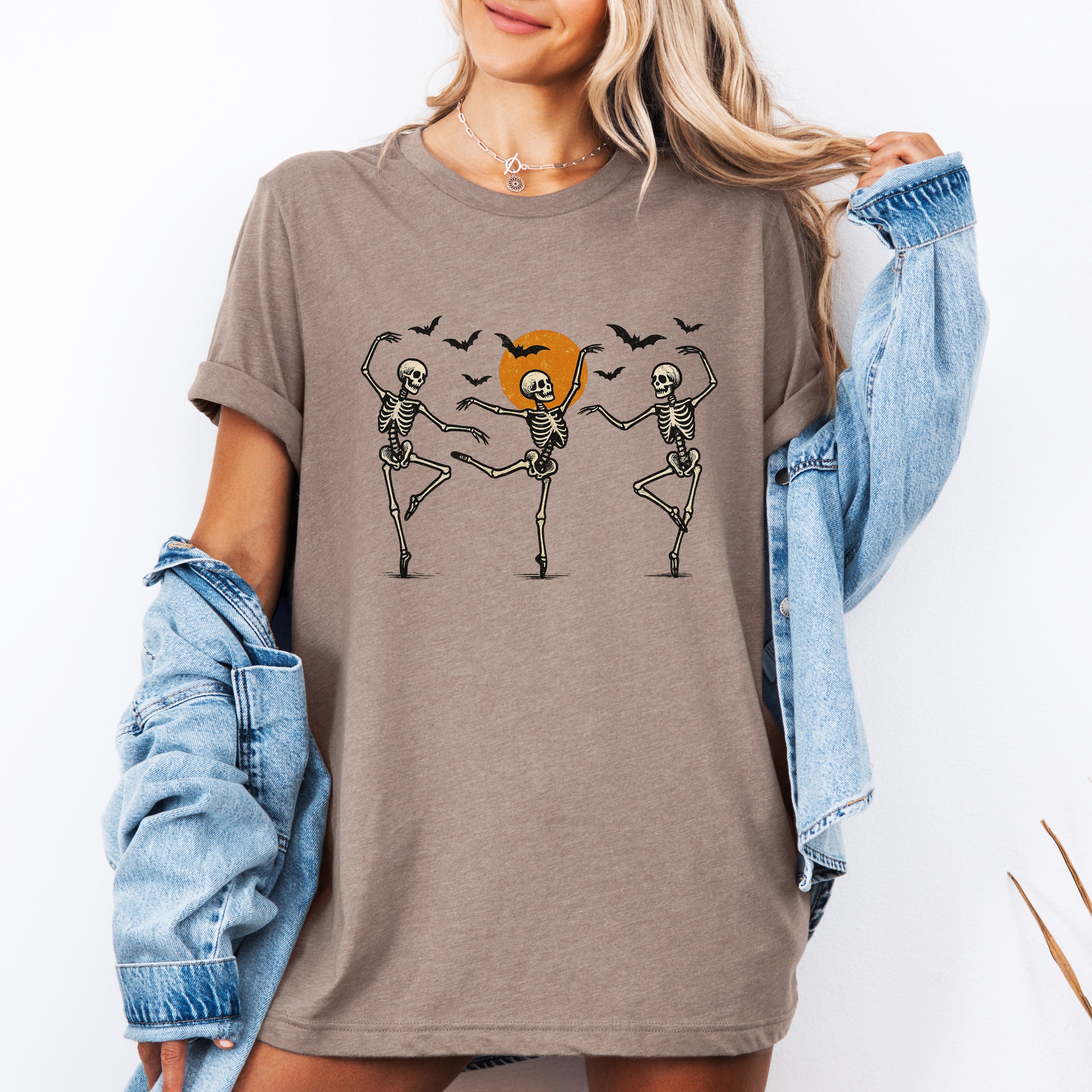 Skeleton Dancers Halloween Themed Spooky Dance Illustration With Playful Grinning Skulls Graphic Tee